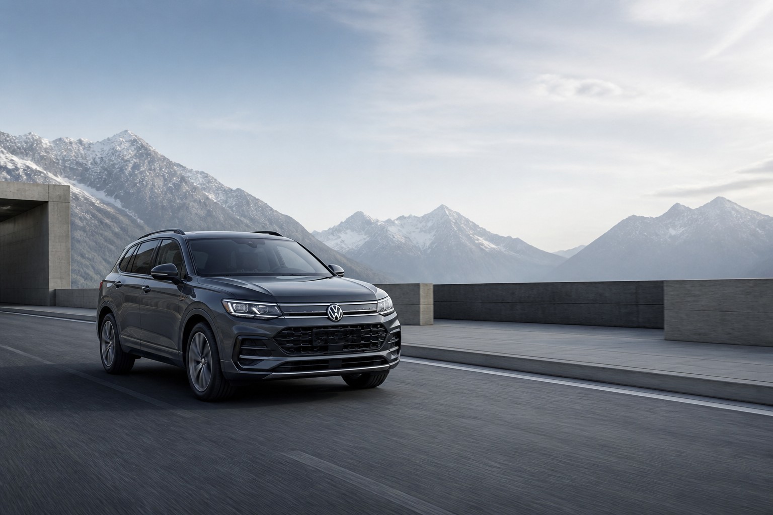 Representative graphite Volkswagen Tayron-style SUV on a modern alpine road